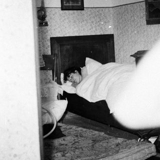 Person sleeping in a bed inside a room.