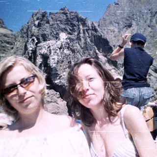 People on a boat with a mountain backdrop.