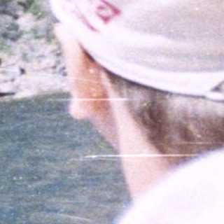 People view a river with steep, rocky cliffs.