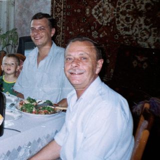 Family seated at a table with food and drinks.
