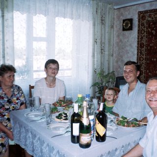 Family seated at a table with food and drinks.