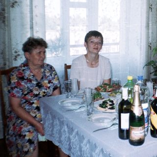 Family seated at a table with food and drinks.