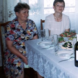 Family seated at a table with food and drinks.