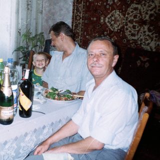 Family seated at a table with food and drinks.