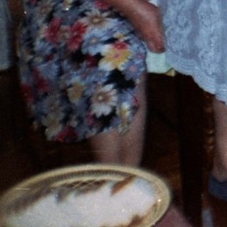 Family seated at a table with food and drinks.
