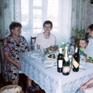 Family seated at a table with food and drinks.