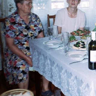 Family seated at a table with food and drinks.