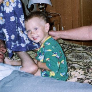 Man in bed, woman and child appear concerned.