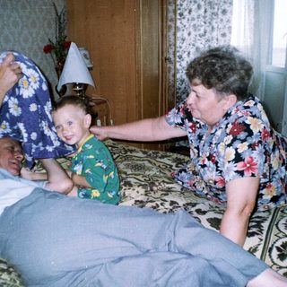 Man in bed, woman and child appear concerned.