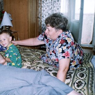 Man in bed, woman and child appear concerned.