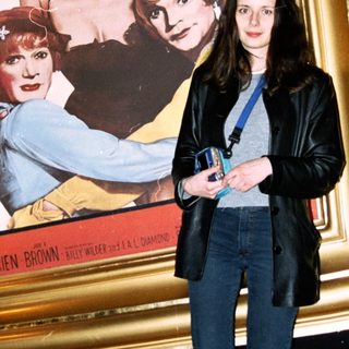 Woman stands before "Some Like It Hot" movie poster.