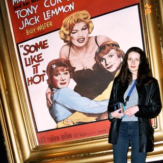 Woman stands before "Some Like It Hot" movie poster.