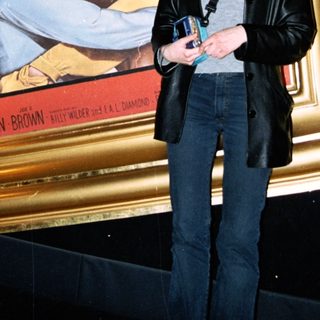 Woman stands before "Some Like It Hot" movie poster.
