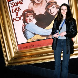 Woman stands before "Some Like It Hot" movie poster.