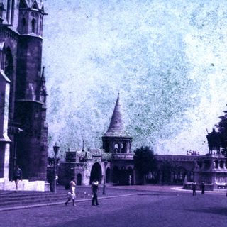 Vintage image shows architecture, street, and people in a city.