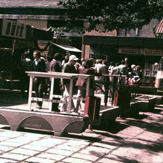 Vintage train ride with passengers in a public space.