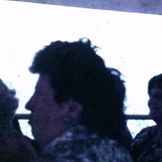 People seated indoors, possibly on a boat or public transport.