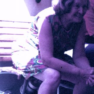 Woman sits next to a man, basket nearby.