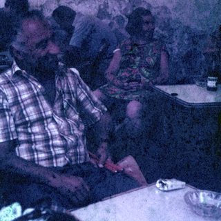 Two people seated at a table, possibly in a restaurant.