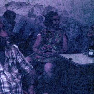 Two people seated at a table, possibly in a restaurant.