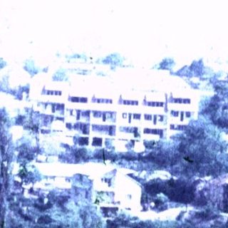 A road descends a hillside toward a town.