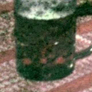 Group of people seated at a table, drinking beer.