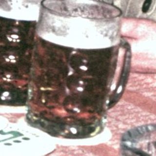 Group of people seated at a table, enjoying drinks.