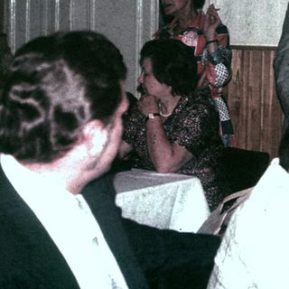 Group of people socializing in a room with decorations.