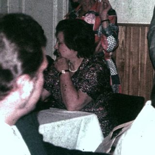 Group of people socializing in a room with decorations.