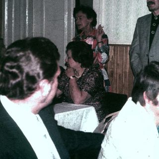 Group of people socializing in a room with decorations.