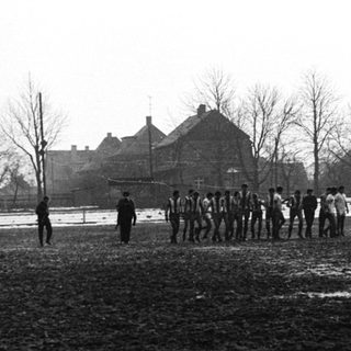 Group of people standing in a snowy, wintry landscape.