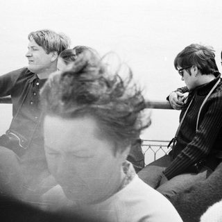 Men on a boat, looking out over water.