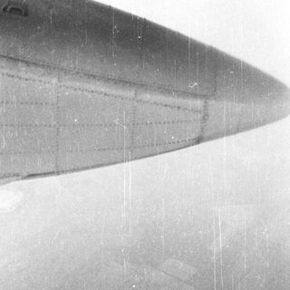 Here's a brief summary of the image: Black and white image of an aircraft wing's cross-section.