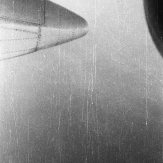 Close-up of a plane's wing, showing age and wear.