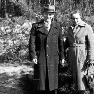 Black and white photo shows a couple standing outdoors.