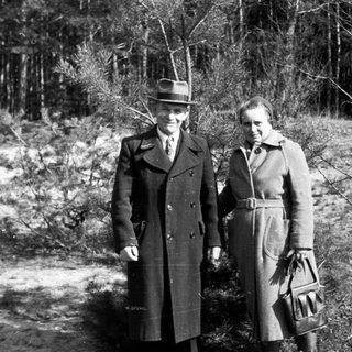Black and white photo shows a couple standing outdoors.