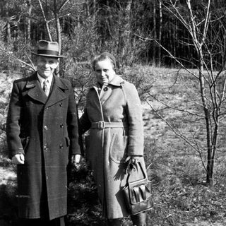 Black and white photo shows a couple standing outdoors.