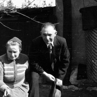 Black and white photo of a couple outside a building.