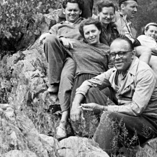 Group of people posing on a rocky hillside.
