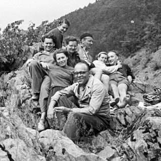 Group of people posing on a rocky hillside.