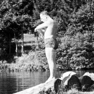 Boys enjoy a waterfall and swimming in a river.