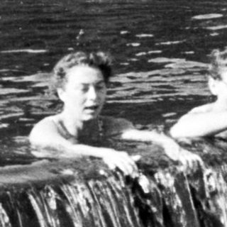 Boys enjoy a waterfall and swimming in a river.