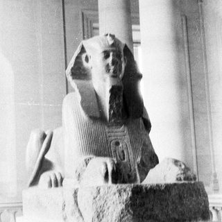 Black and white photo depicts an ancient Egyptian sphinx statue.