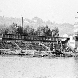 Rowing regatta with spectators and a control tower.
