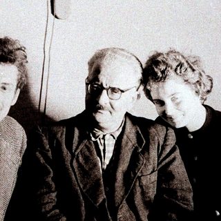 Einstein, Bohr, and Pauli photographed together in a seated group.