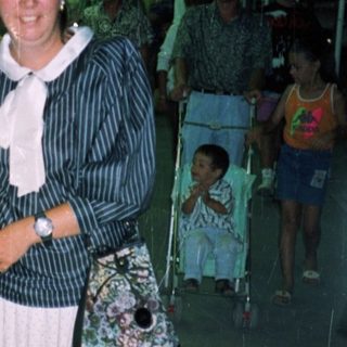 Two women standing indoors, appearing to be in a store.
