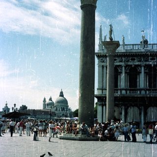 Piazza San Marco, Venice, Italy, with crowds and architecture.
