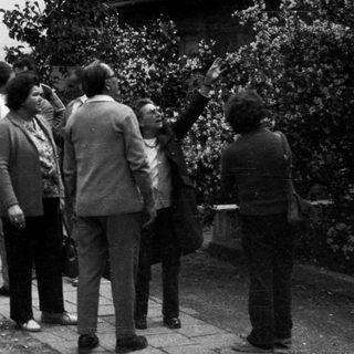 Group of people walk along a paved path.