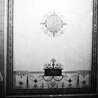 Elaborate black and white ornamental design on a wall.