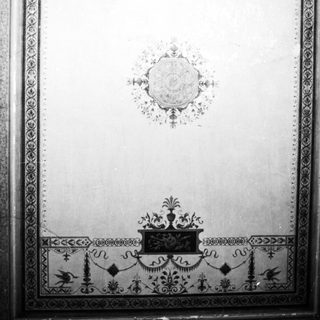 Black and white image of ornate wall paneling design.